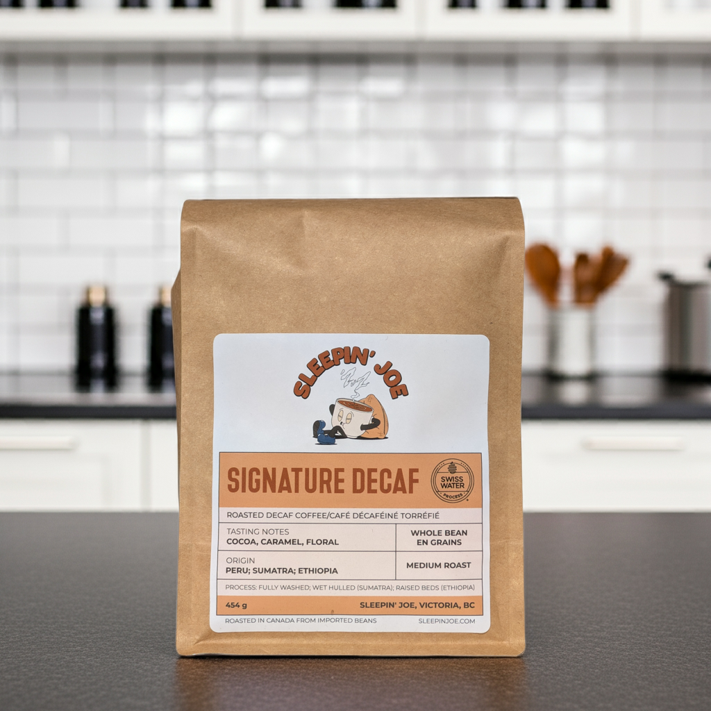 Coffee bag labeled 'Signature Decaf' by Sleepin' Joe on a kitchen counter.